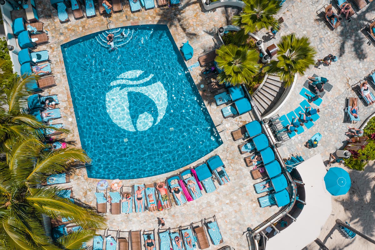 Stunning aerial view of a colorful resort pool area in Honolulu