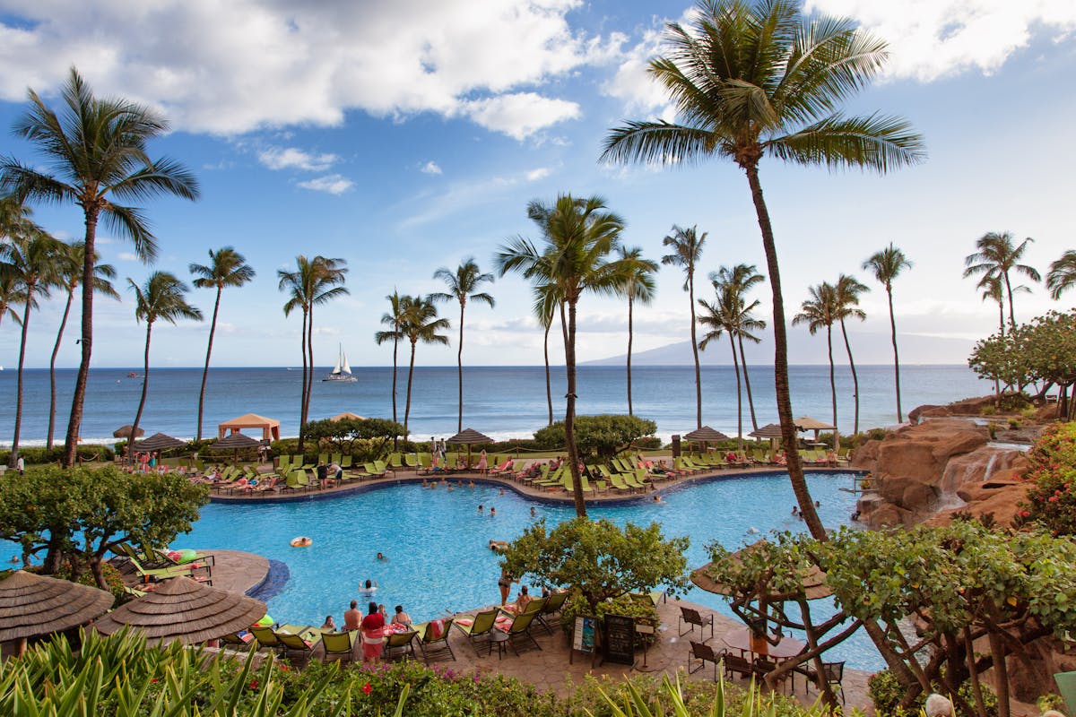 Tropical beach resort with palm trees and a sparkling pool in Kaanapali Hawaii